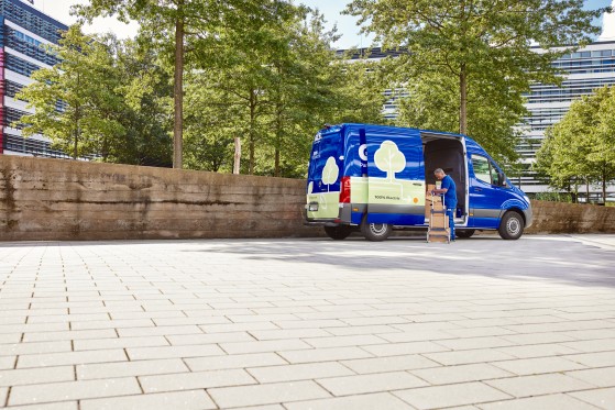 GLS driver at GLS delivery vehicle loading parcels