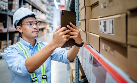 Man looking at his phone in a warehouse